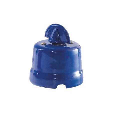 Comutador de porcelana com laço de cor vermelha.