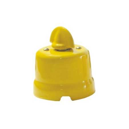 Comutador de porcelana com laço de cor vermelha.