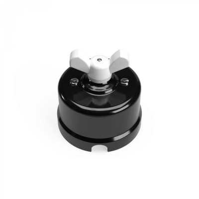 Comutador de porcelana preto com laço colorido.